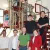 The Mach-X research team posing for a photo in their lab with scientific machinery behind them