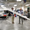 two men folding 11-foot sailplane